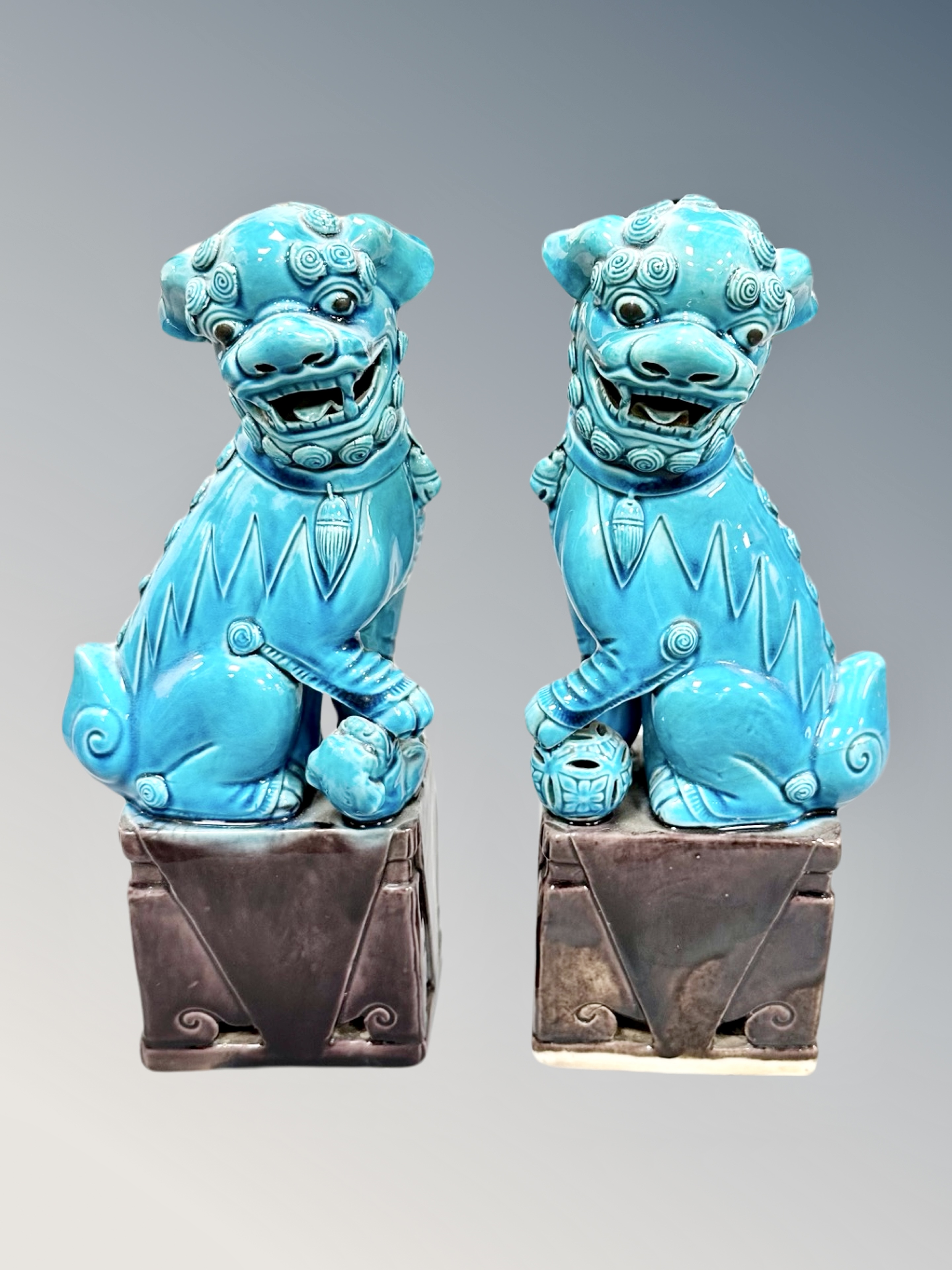 A pair of Chinese porcelain turquoise glaze foo dogs,