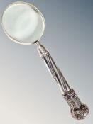 A large magnifying glass with silver-plated handle