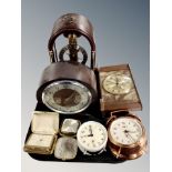 A group of mantel clocks and alarm clock