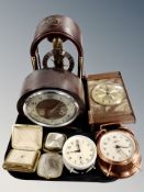 A group of mantel clocks and alarm clock