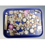 A tray of coins, badges,