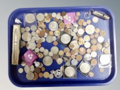 A tray of coins, badges,