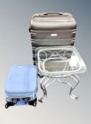 A contemporary glass topped lamp table on metal base together with IT hard shell luggage case and