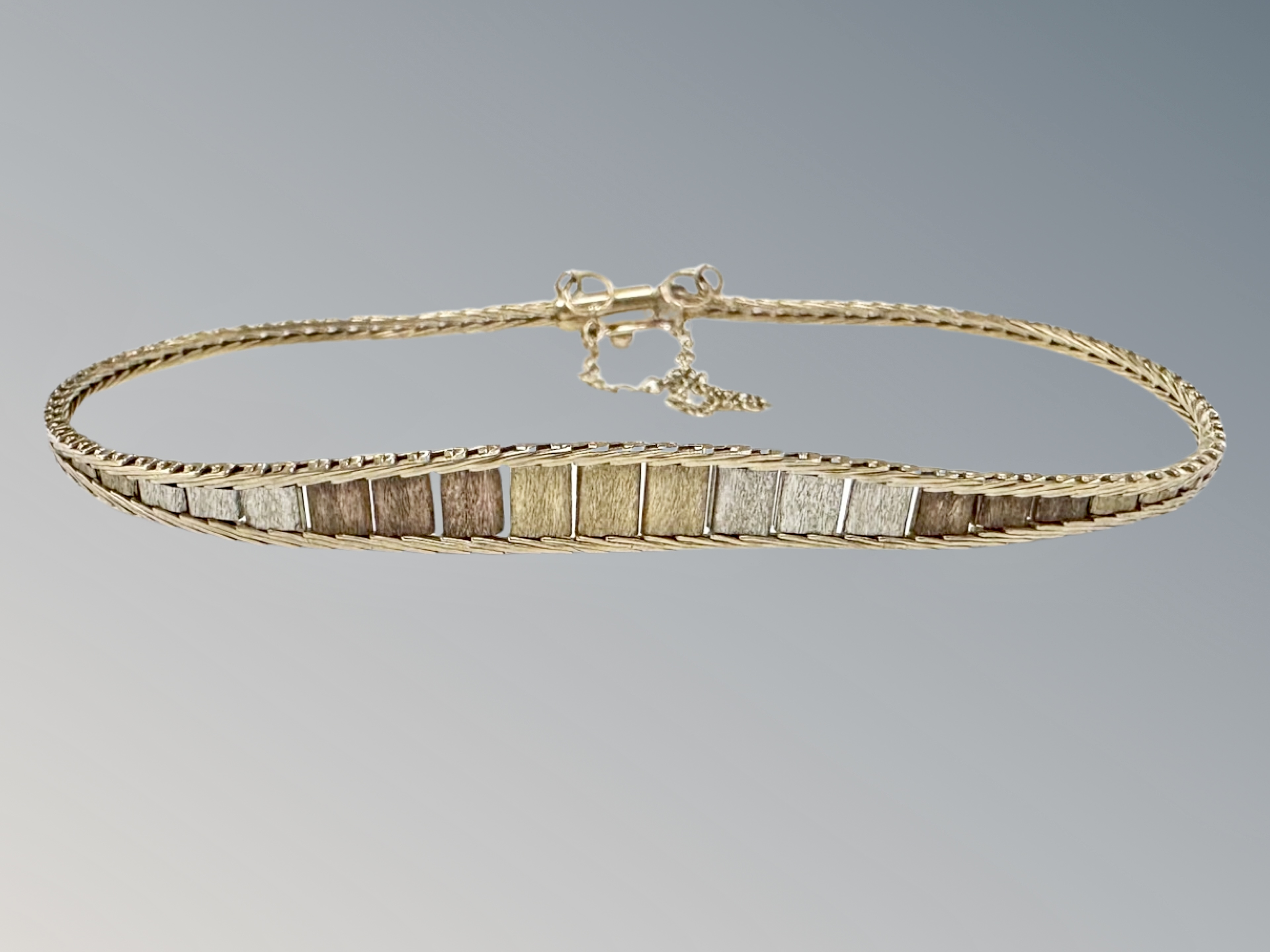 A three-tone 9ct gold bracelet CONDITION REPORT: 5.