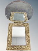 An antique brass embossed framed bevelled mirror together with a further circular bevelled mirror