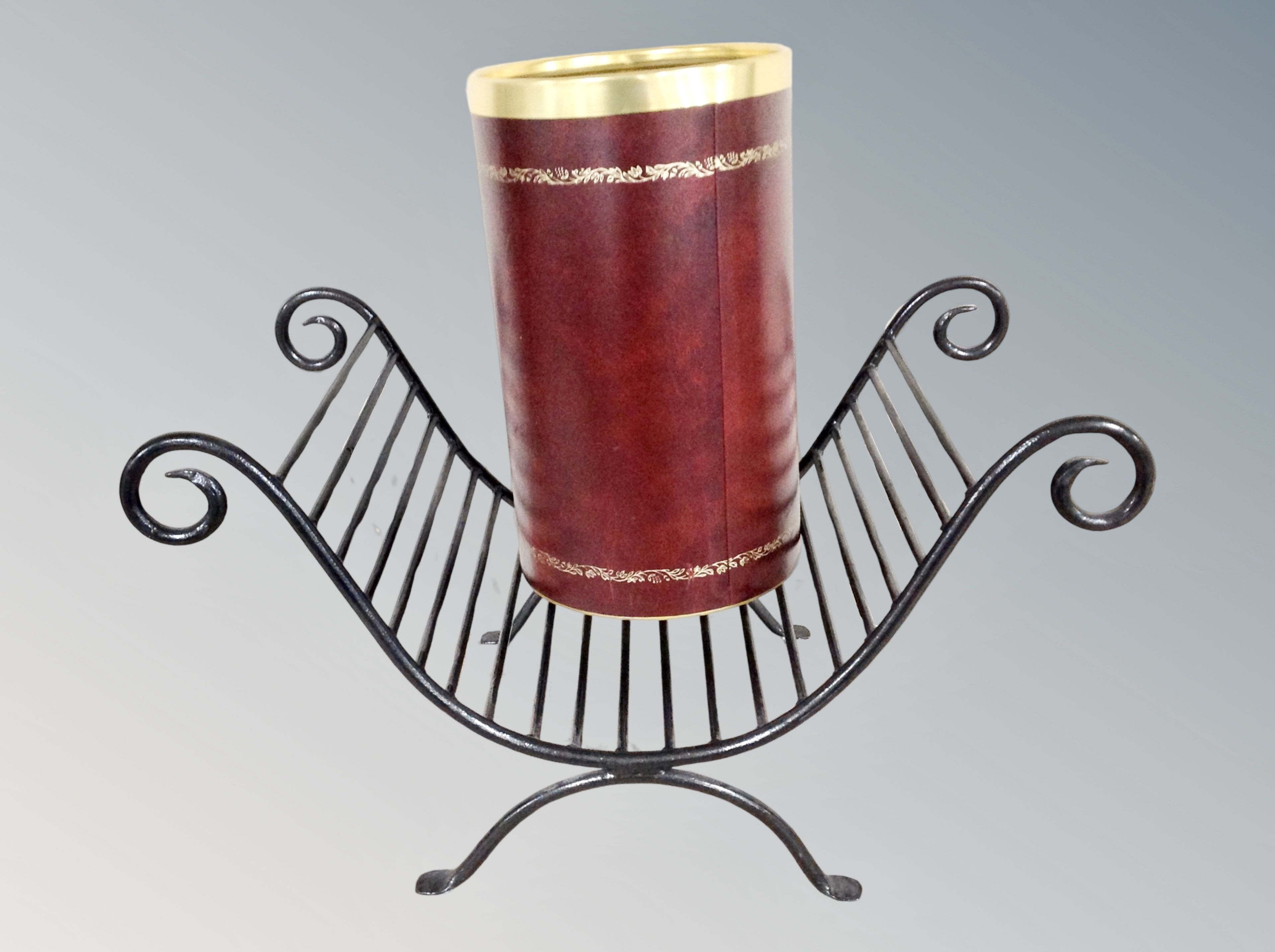 A wrought metal log stand together with a leather bound bin