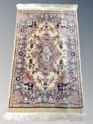 A fringed rug of Persian design,