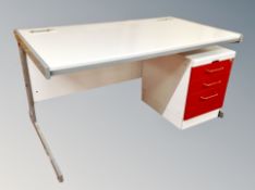 A contemporary metal framed office table with under desk filing chest