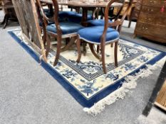 A Chinese fringed floral carpet on blue ground,