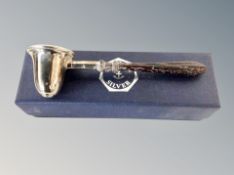 A silver candle snuffer