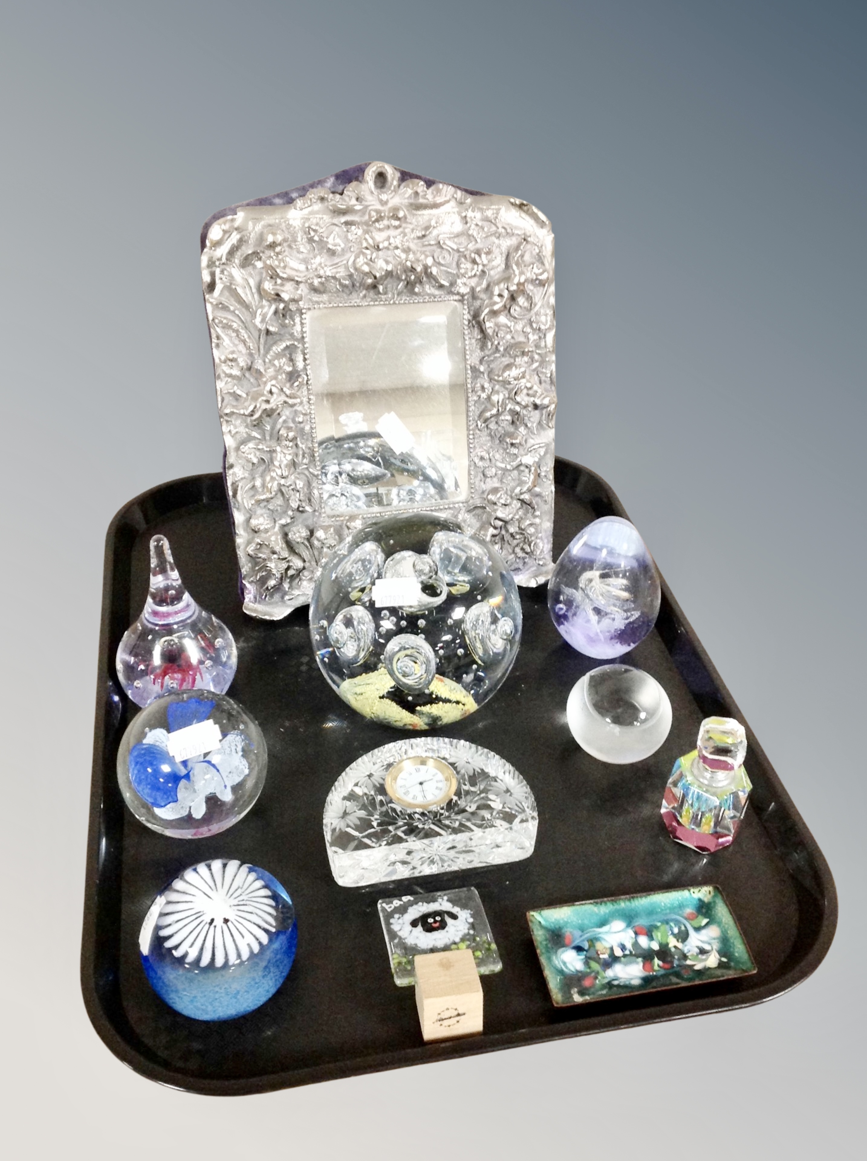 A tray of glass paperweights, decorative easel mirror,