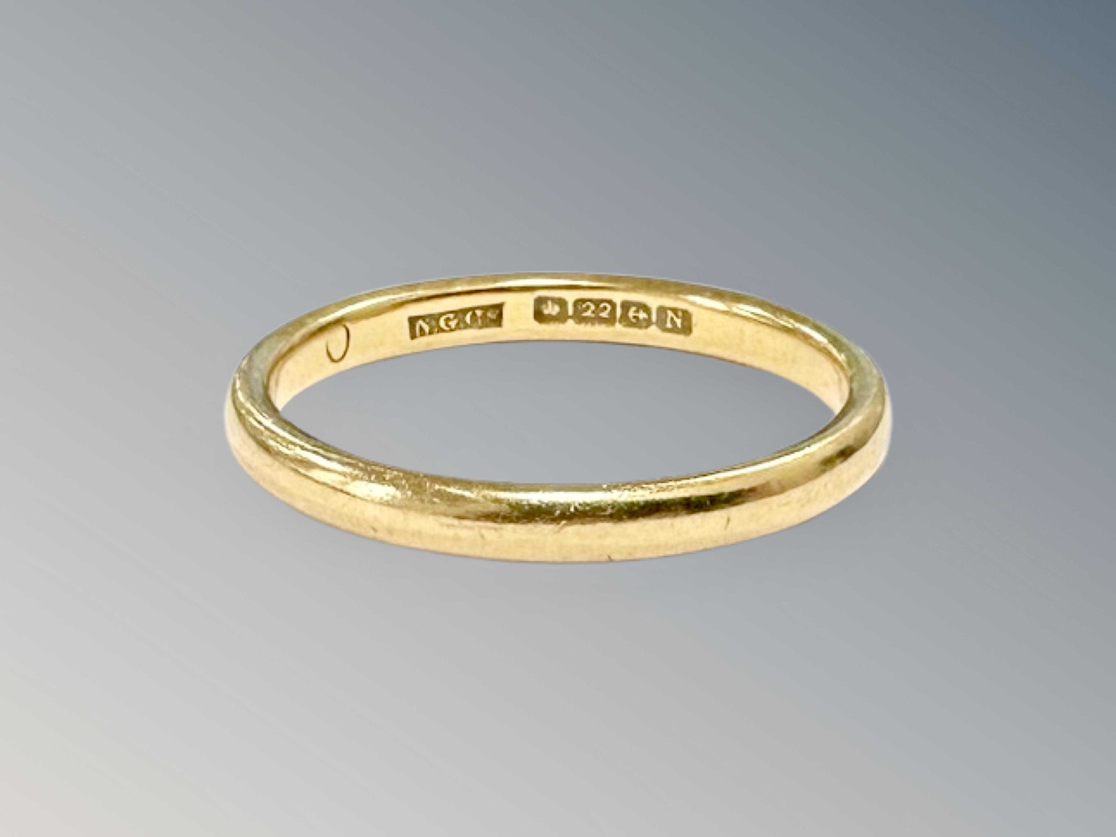 A 22ct gold band ring, size P½ CONDITION REPORT: 3.