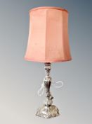 An ornate silver plated table lamp with shade,