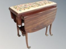 A 20th century mahogany flap sided serving trolley together with a tapestry duet footstool