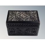 A carved oak playing card box