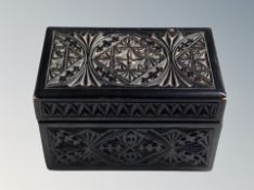 A carved oak playing card box