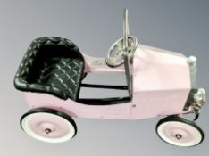 A pink Kalee pedal car in the form of a 1933 motorcar