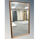 A 1970's teak framed mirror,