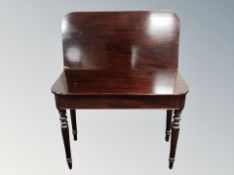 A Victorian mahogany turn over top tea table on reeded legs