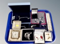 A tray of costume jewellery, bedroom clock,