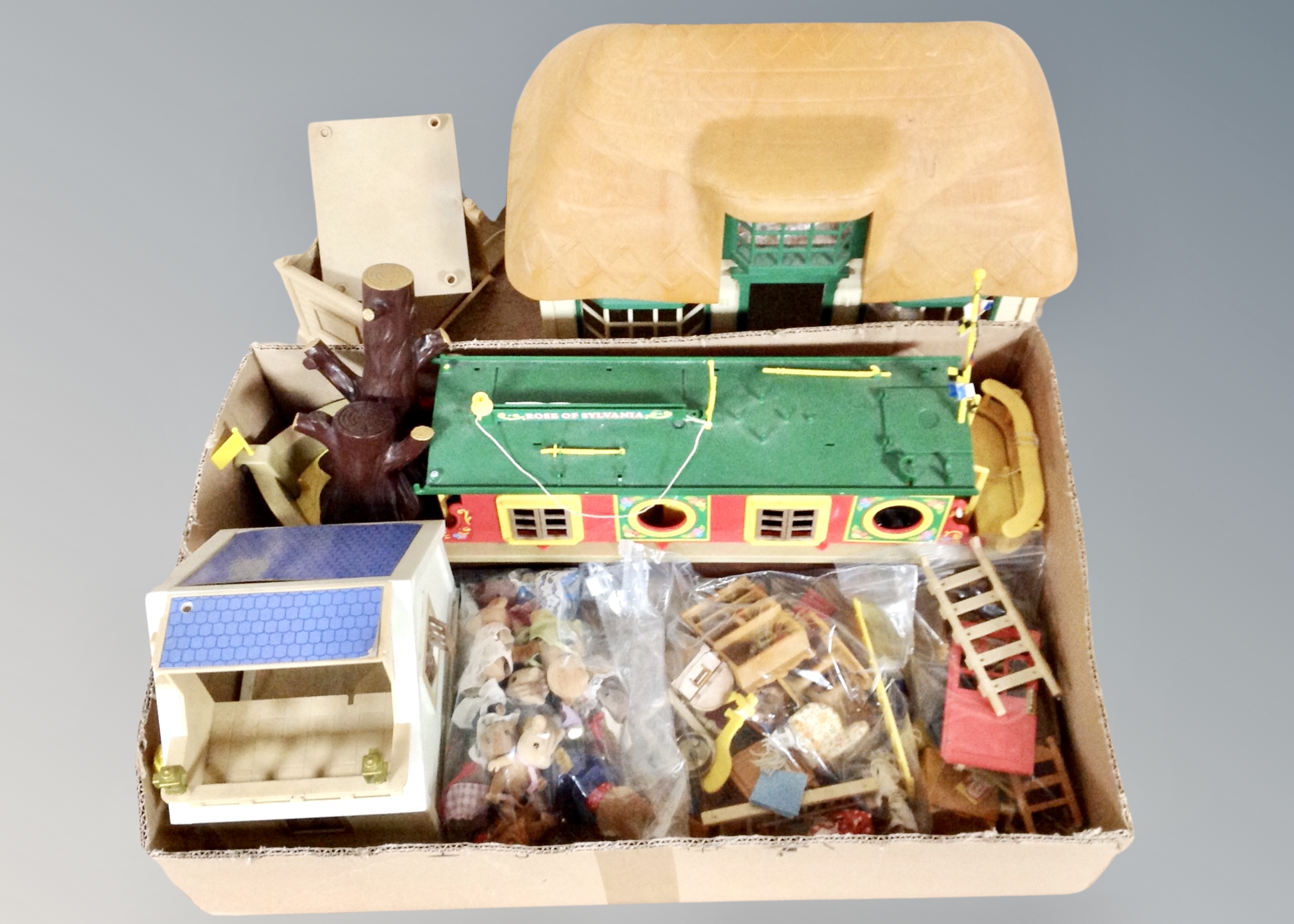 A Sylvanian Families barge boat and cottage with figures and accessories