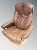 A Stressless Ekornes brown leather upholstered swivel relaxer chair