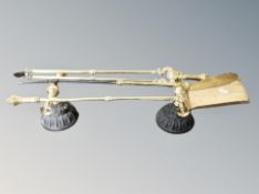 A pair of 19th century cast iron and brass fire iron stands together with three brass fire