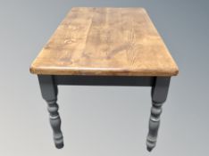 A pine farmhouse kitchen table on painted legs plus four ladder back chairs