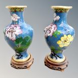 A pair of Japanese cloisonné vases on wooden stands,