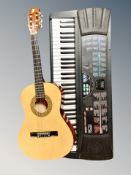 An Optimus MK-803 BL electric keyboard with lead together with a Herald Acoustic guitar