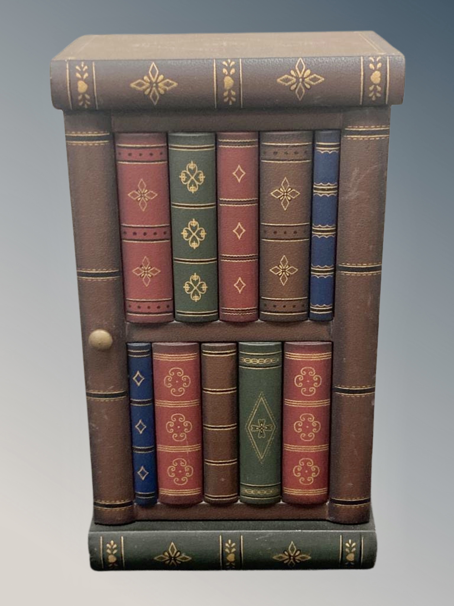 A small cabinet in the form of a stack of books,