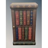 A small cabinet in the form of a stack of books,