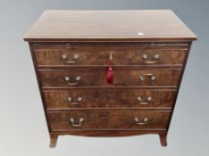A George III style mahogany four drawer chest with slide