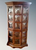 A shaped double display cabinet with glass panel doors in oak finish CONDITION REPORT: