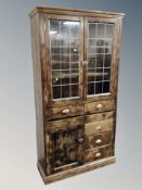 A stained pine double glazed leaded glass door kitchen cabinet fitted with drawers