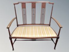 A late 19th century inlaid mahogany settee in classical fabric
