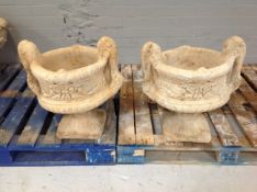 A pair of concrete classical garden planters on stands