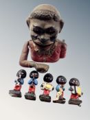 An antique cast iron money box and five Robertson's band figures