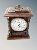 A Europa two-jewel carved bedroom clock