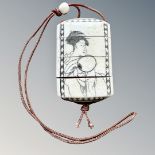 A Japanese bone and penwork inro depicting a geisha holding a fan and a bird in blossom to the