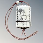 A Japanese bone and penwork inro depicting a geisha holding a fan and a bird in blossom to the