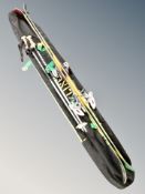 A pair of Line skis with bindings and Rossignol poles in carry bag