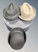 A vintage hat box containing Dunn & Company bowler hat and two further hats