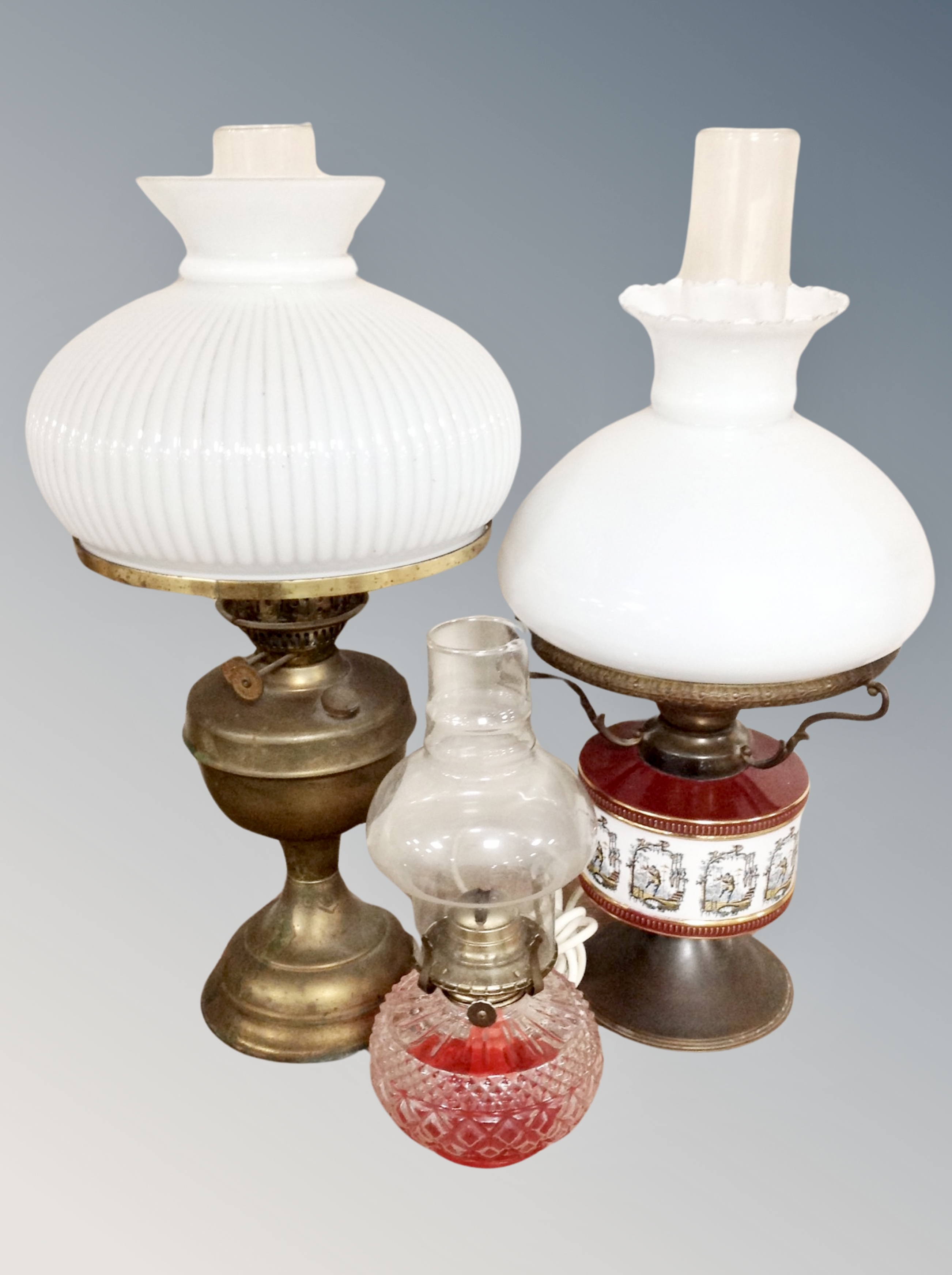 A brass Duplex vintage oil lamp with chimney and shade and two further oil lamps