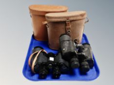 Two leather cased sets of field glasses,