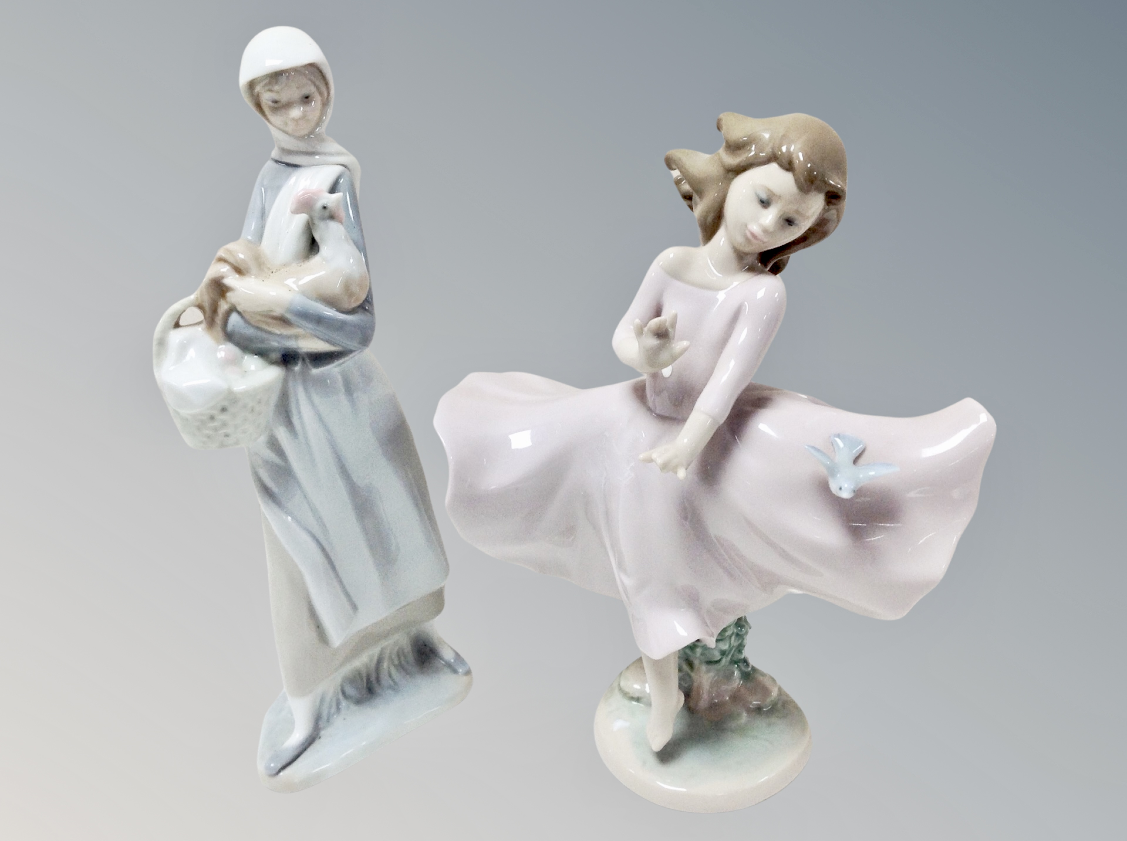 A Lladro figure of a lady with chicken,
