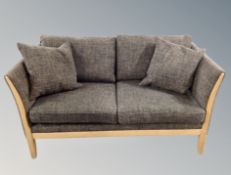 A late 20th century Danish two seater oak framed settee in grey fabric