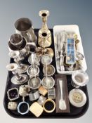 A tray of silver plated and other metal wares, set of six egg cups, two pairs of candlesticks,