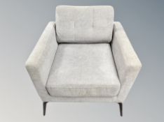 A Scandinavian armchair in grey upholstery