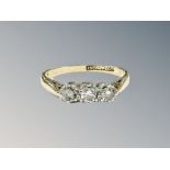 An 18ct gold three stone diamond ring, size N CONDITION REPORT: 2.